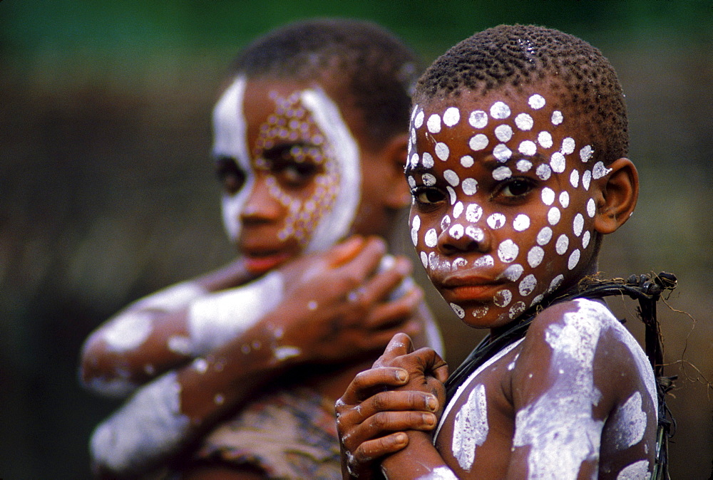 Children's faces painted with white at a Menstrual Ceremony in Pemba.