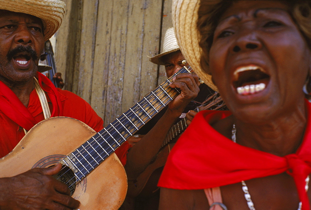 A musical troupe sing to passers-by to celebrate Carnaval in Santiago de Cuba.