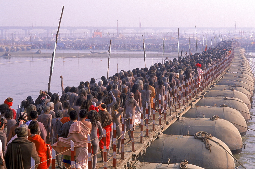 Naked sadhus return to their camps along the Ganges river after having taken a holy and purifying dip during the maha Kumbh mela in Allahabad India.