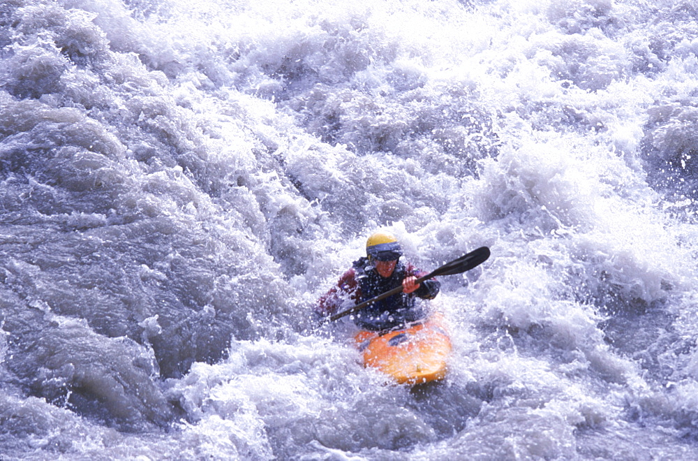 A kayaker makes her way through Class IV rapids outside of Queenstown on the South Island of New Zealand.