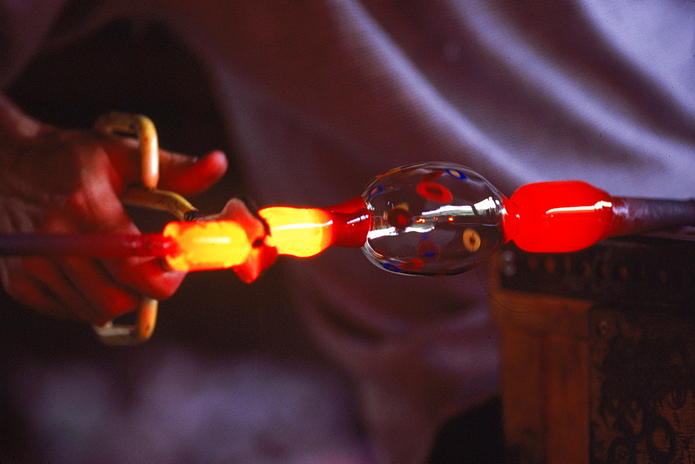 A glass blower creats a one of a king goblet at his studio in Nelson, New Zealand.