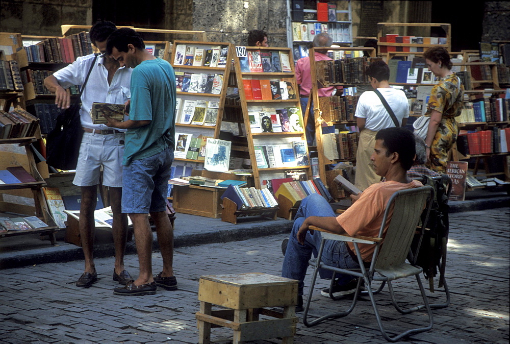 Vendors selling books in a park in the Plaza de Armas in Old Havana, Cuba