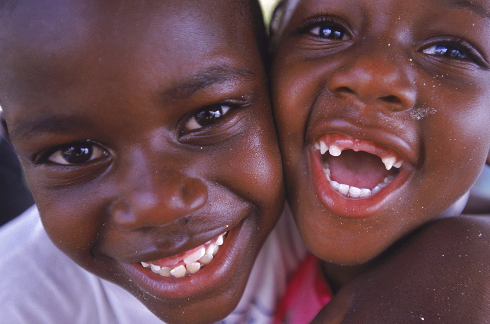 A brother and sister share a laugh and a hug at their home on Cat Island in the Bahamas.