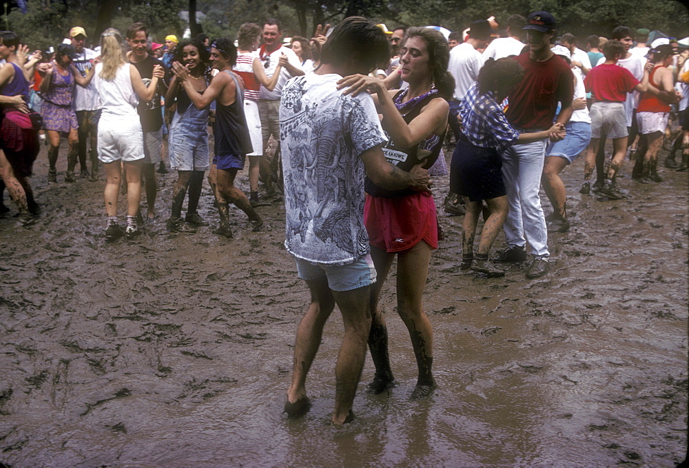 Festival goers dance in the mud to Cajun music at the annual Festivals Acadiens, Lafayette, Louisiana