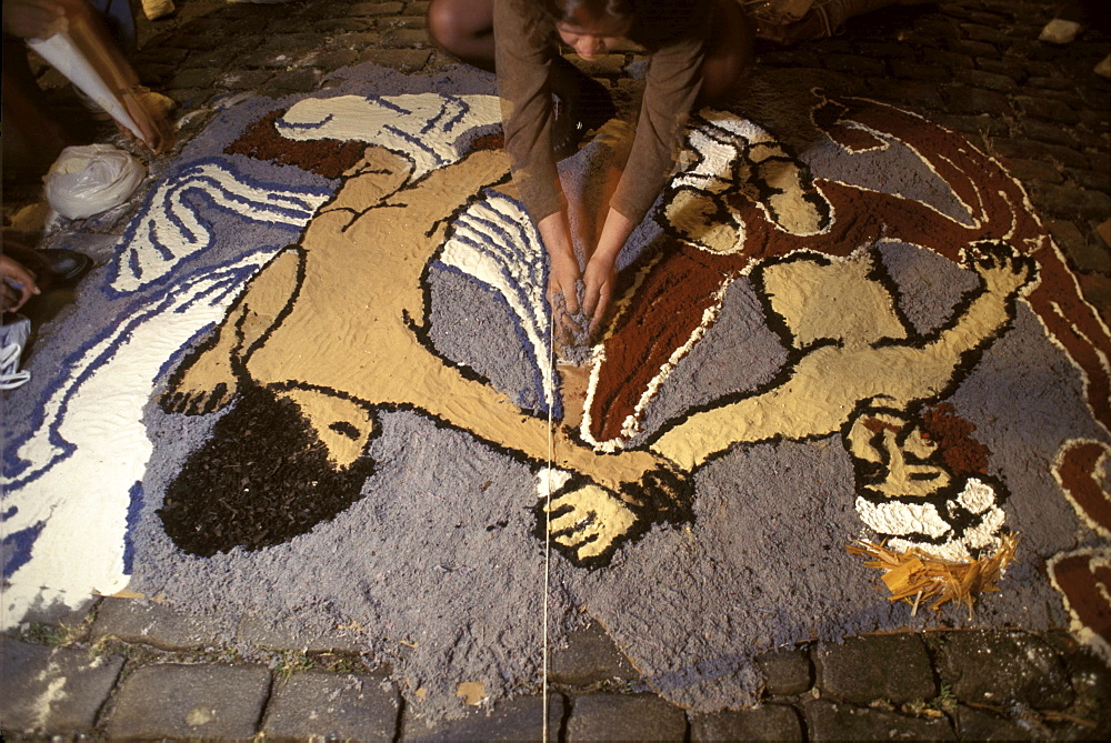 In preparation for a procession in honor of the resurrection on the morning of Easter Sunday, citizens of Ouro Preto, Brazil, lay out an elaborate carpet of sawdust and flower petals through the cobbled streets.