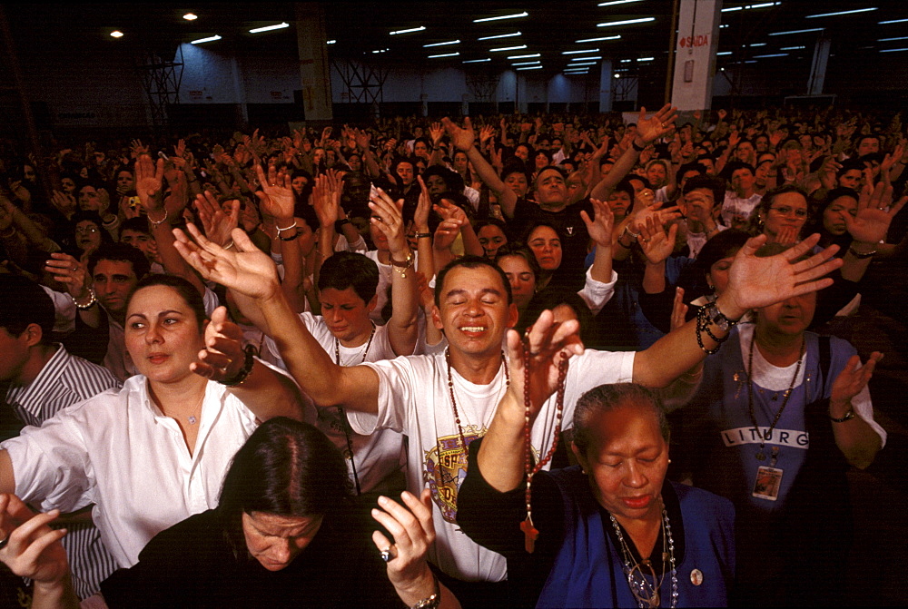 Worshippers at a service by Brazil's charismatic Padre Marcelo Rossi are encouraged to sing, shout and speak in tongues much like their Pentecostal counterparts, yet Catholic traditions, such as communion are preserved. This image is part of a five-part series on the rise of evangelical Protestantism in Latin America.