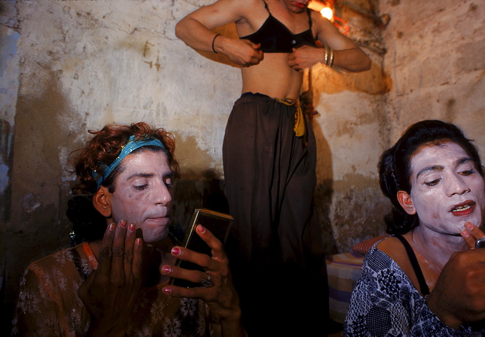 Hijras (left to right) Sajjda, Gori and Neeli get dressed before heading out to go begging on the streets