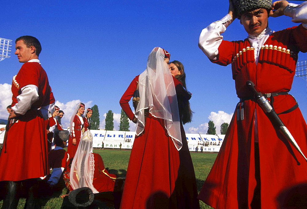 Dancers from a traditional Abkhazian folkdance group adjust their costumes before a performance during a celebration on September 30, 2003 commemorating ten years of "independence" from Georgia, in Sukhum, Abkhazia