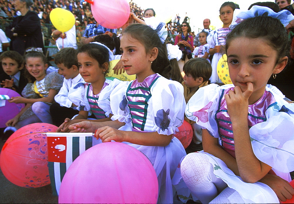 Young girls with Abkhaz flags wait for their turn to perform during a gala show at the main stadium in Sukhumi, celebrating ten years of "independence" from Georgia, and the ten year anniversary of the end of the war, in Sukhum, Abkhazia.