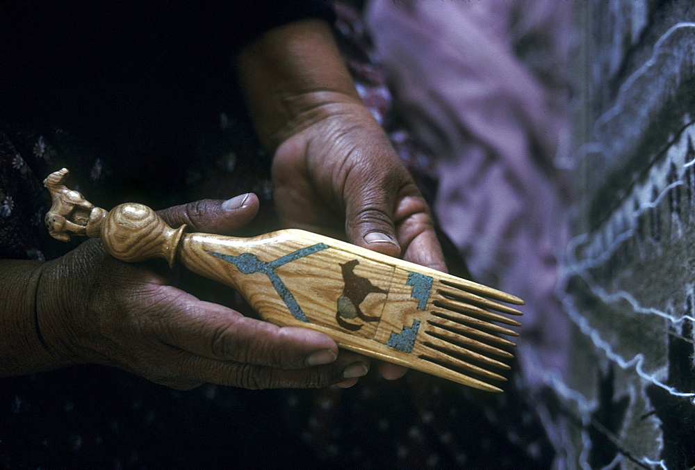 A Navajo weaver displays her handmade comb in her home in Burnham, New Mexico on the Navajo Indian Reservation.