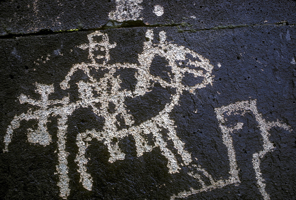 Historic petroglyph carved into a volcanic ridge in the Galesteo Basin near Santa Fe, New Mexico