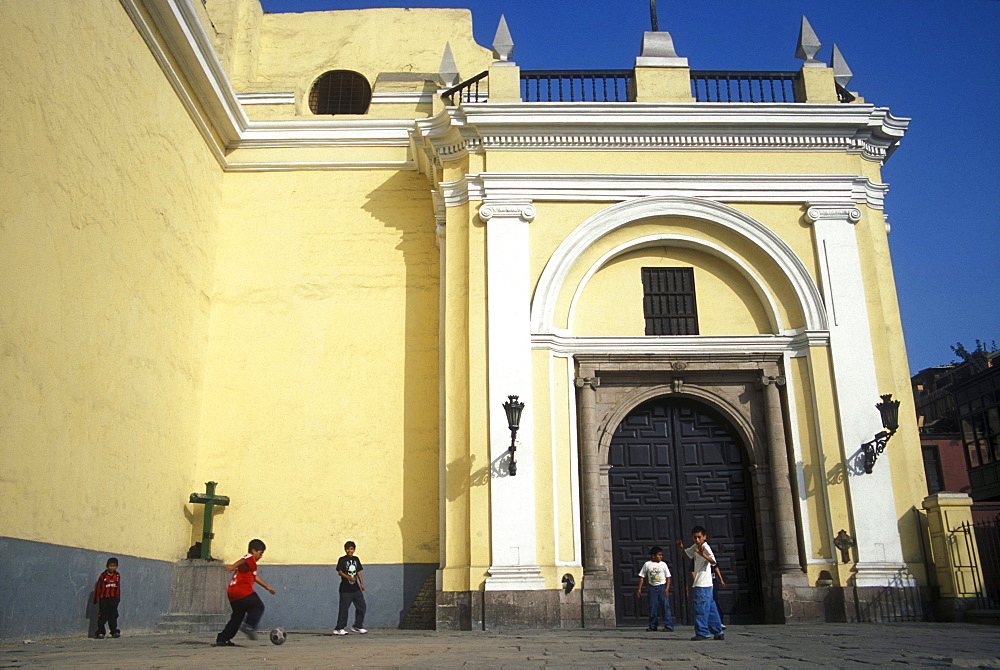 Soccer game in front of the Monasterio de San Francisco in central Lima, Peru