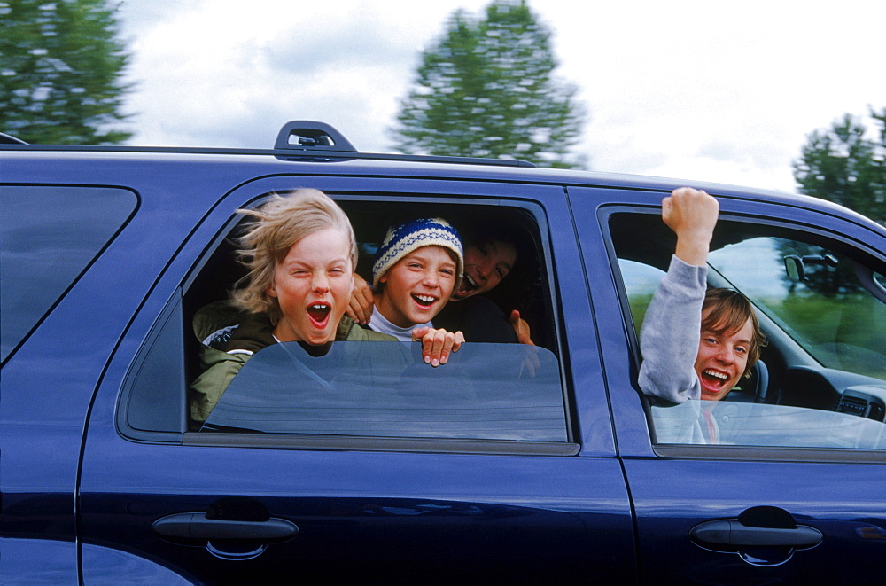 Burton Snowboards Youth team on a roadtrip in Oregon. Kids playing in car.