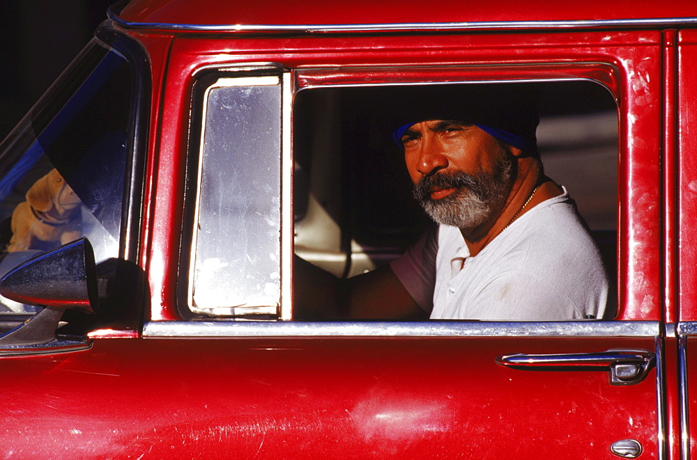 The artist Salvador Gonzalez Escalona, in his vintage auto in the streets of Havana, Cuba. Gonzalez Escalona is a famous Havana artist who created an outdoor music and art space in Calle Hamel.