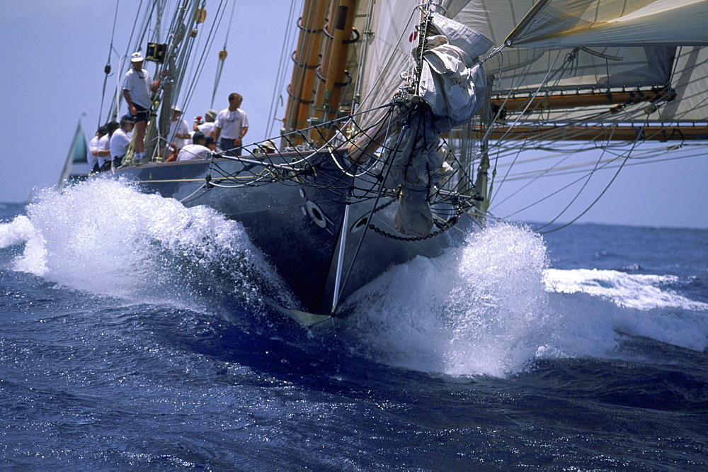 The crew of a 109 foot Herreshoff schooner, a classic racing yacht, sail toward the finish.