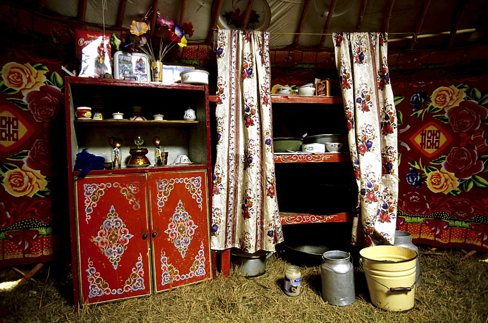 Interior of a ger. The internal layout of a ger is universal throughout Mongolia. Near the door, on the female side (right), are the cooking implements and water buckets. Tavanbogd National Park, Mongolia.