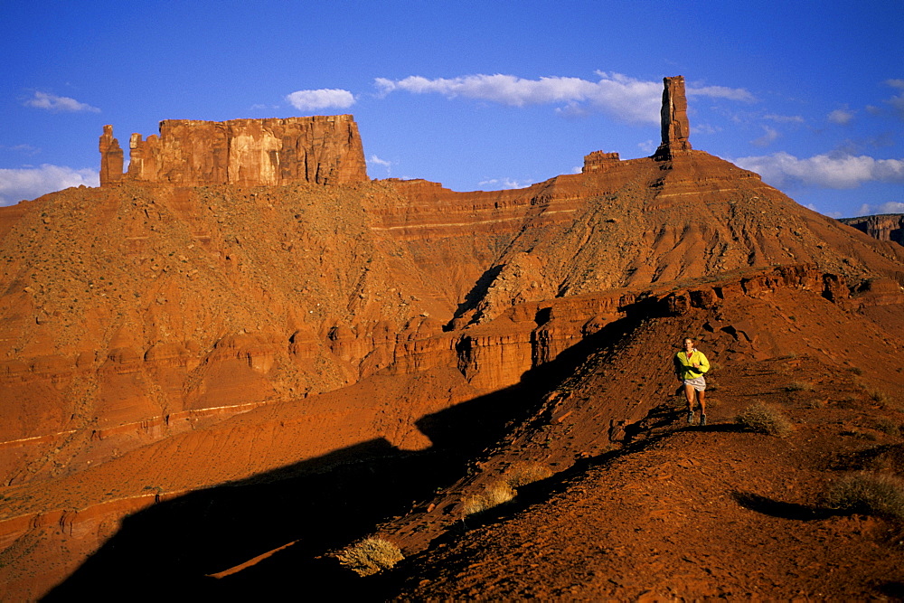 Andi Bither desert running in the far away landscape of Moab, Utah.