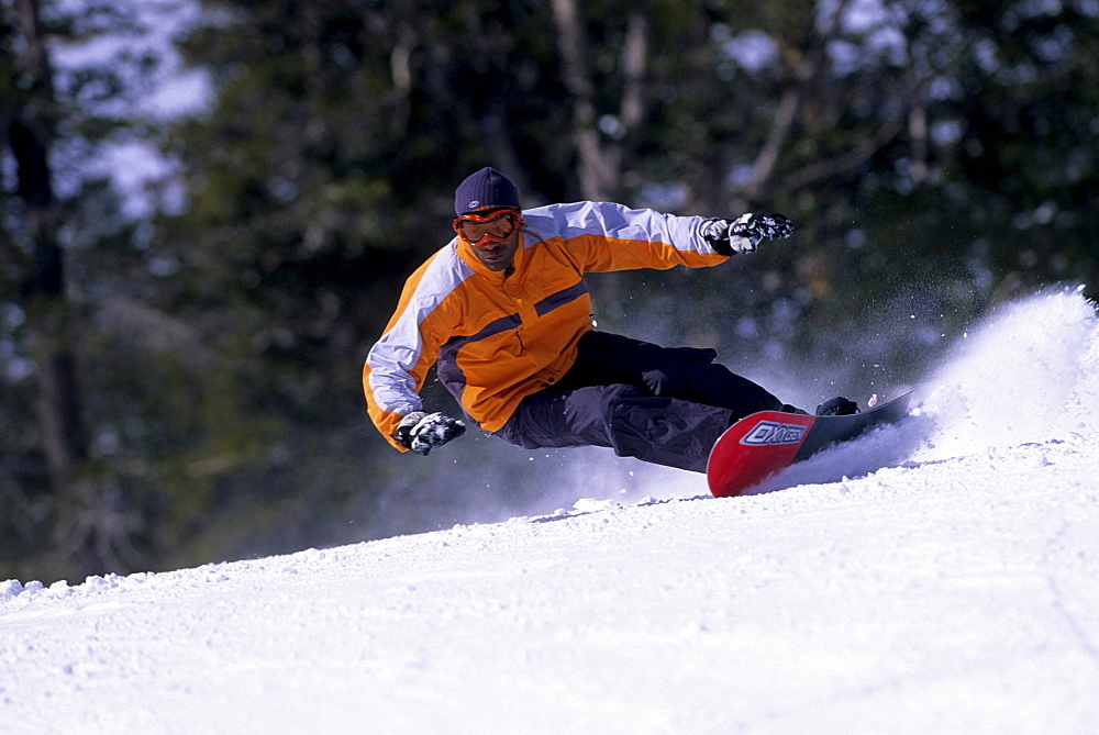 Brian Williams carving turns on his snowboard at Heavenly, California.