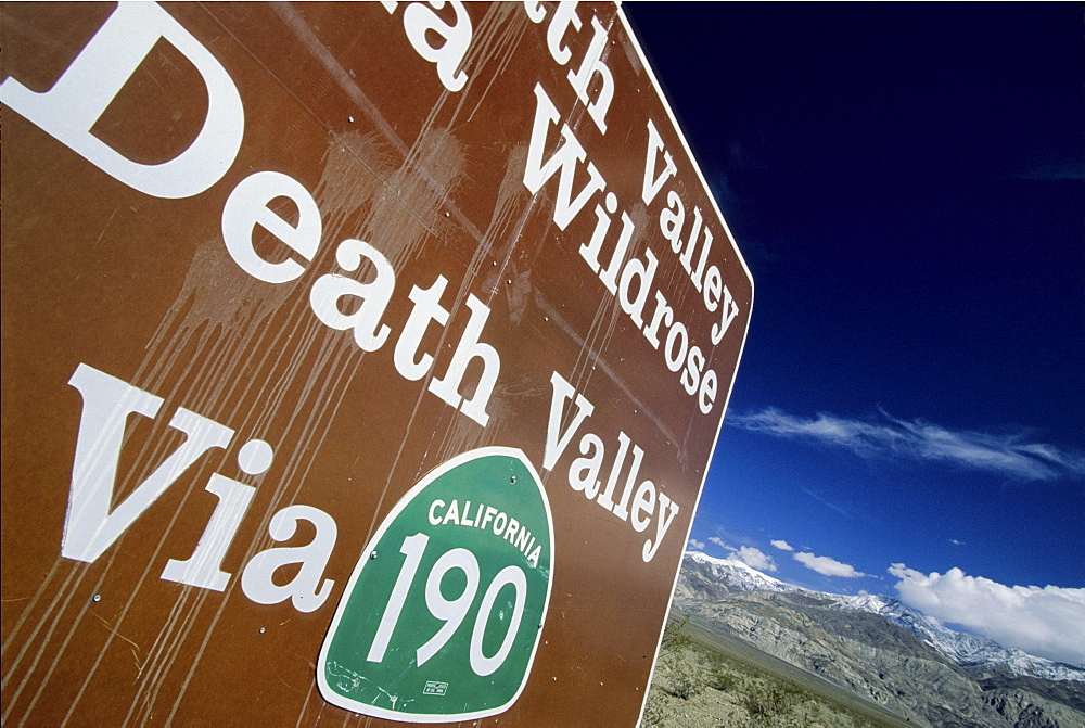 A Road sign on CA 178 between Trona and Death Valley National Park with snow covered Telescope Peak (11049 ft, 3369 m) in the background in Panamint Valley, California on february 15, 2004. Although Death Valley is considered the hottest place on earth some summits in the park receive few feet of snow every winter.