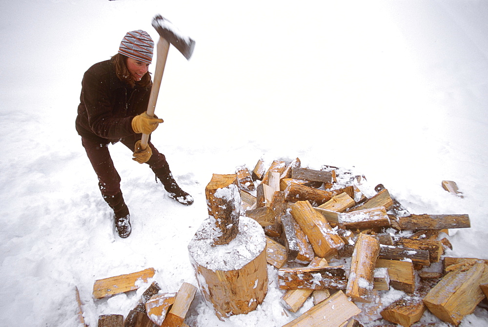 Kit Deslauriers splits logs for firewood in Jackson Hole, Wyoming.