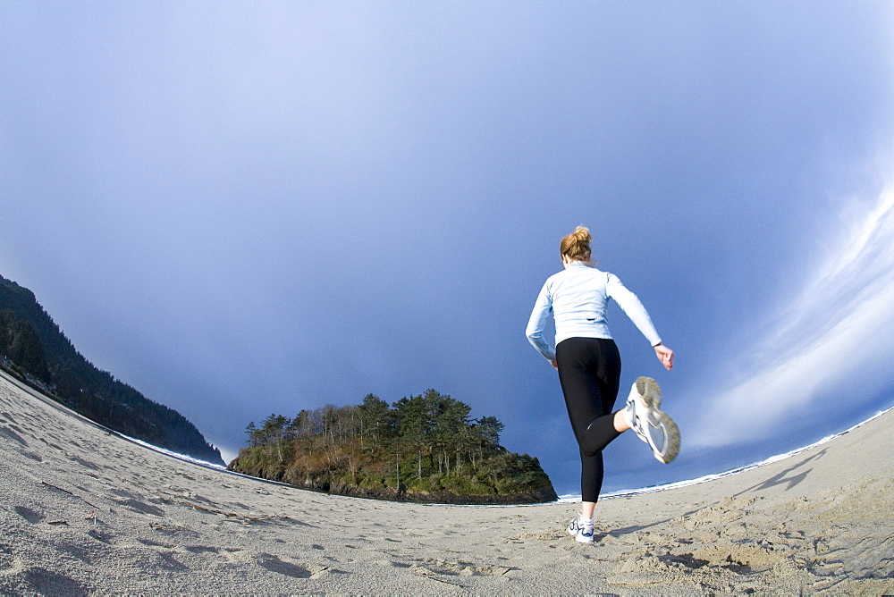 A woman trains at the coast.