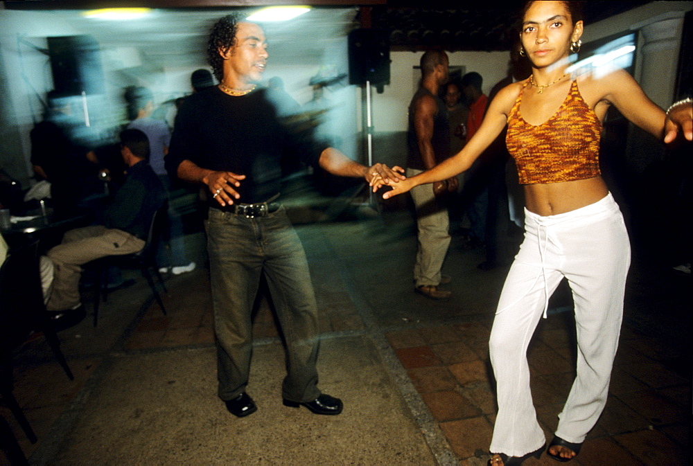 A young Cuban couple dances to a live salsa band in one of two clubs in the small town of Vinales, in the Vinales Valley, Cuba.  A largely rural region of traditional tobacco farming, the Vinales Valley has become a popular tourist destination.