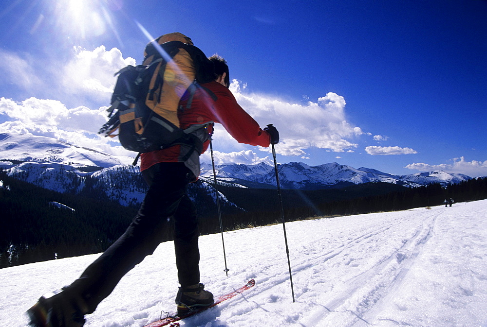 Rolando Garibotti  skis with a pack on the Boreas Pass trail which crosses the Rocky Mountains from Breckenridge to Como, Colorado.  The trail is part of the Rails to Trails system and follows an old railroad grade.  The trail is also part of the 10th Mountain Division Hut System, with a hut called the Section House located along the trail at the top of Boreas Pass.  The trail is within Pike-San Isabel National Forest