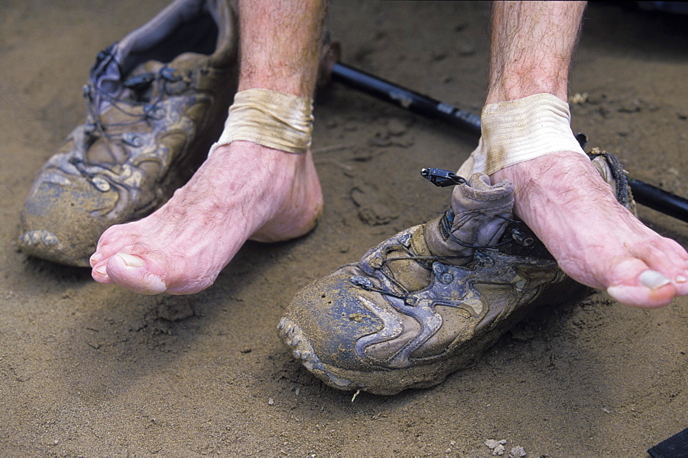 A contestant in a 2002 adventure race in Sapa, Vietnam takes a break to rest his sore, tired feet.