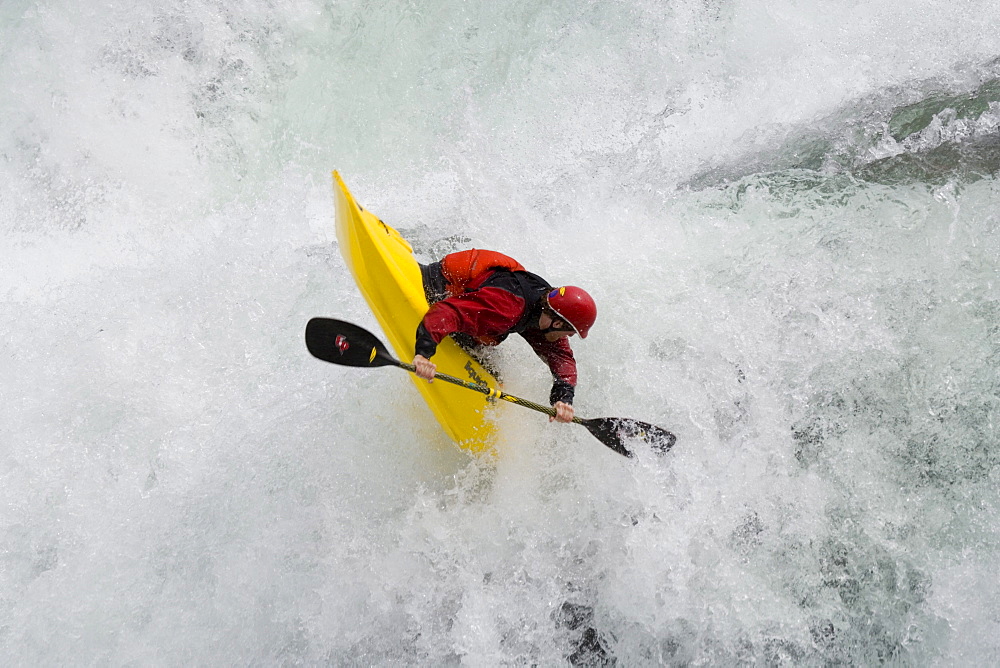 Young man (Trip Jennings) performs "freewheel" move over Kootenai Falls on Kootenai River near Libby, Montana