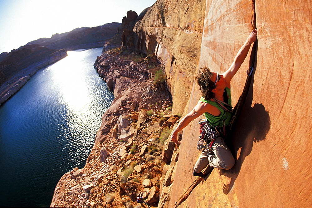 Todd Snyder lead climbing on a first ascent in Lake Powell, Utah