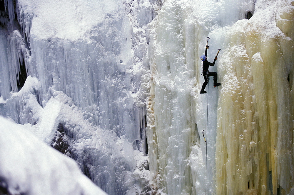 Lizz Grenard at the Ouray Ice Festival uses ice axes and crampons as tools and a rope and harness for safety. The Ouray Ice Festival is held once a year during the Martin Luther King weekend in Ouray, Colorado in the Uncompahgre Gorge.