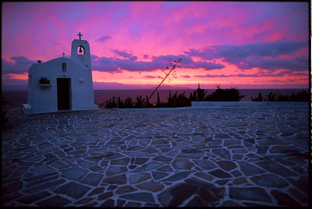 The sun rises over a Greek Chapel perched above the Gulf of Petalion outise of Athens. (Photo by David McLain, Aurora)