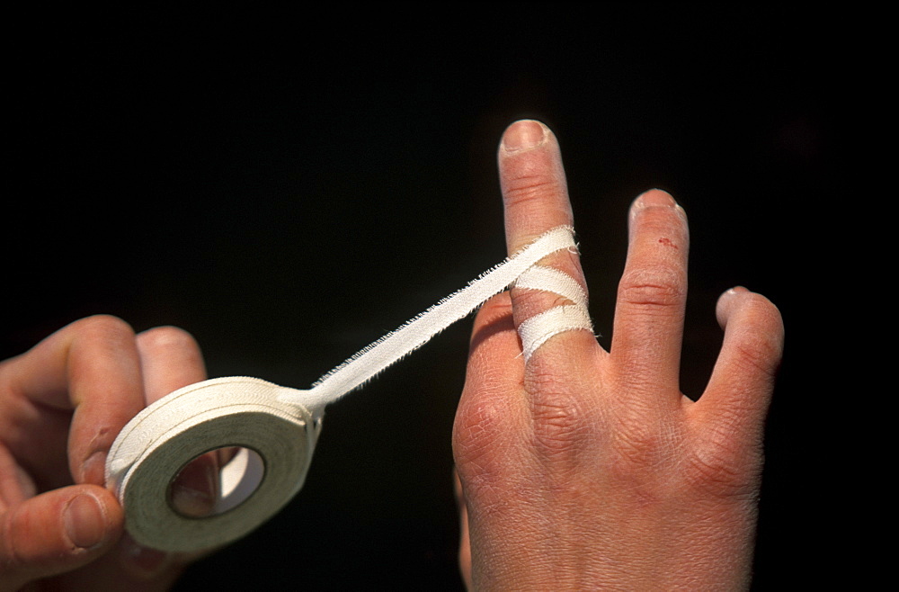 Joi Gallant tapes her tattered hands during a bouldering expedition in Patagonia outside of El Chalten, Argentina.