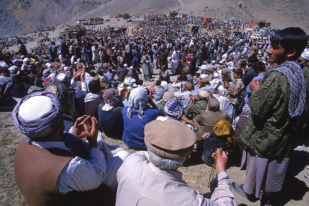 Hundreds of men and boys pray during ceremonies at the shrine of Ahmad Shah Masood in the Panjshir Valley, on the one year anniversary of his assasination, September 9, 2002.. Masood was a revered mujahedin leader who also was one of the leaders of the Northern Alliance which opposed the Taliban and helped the US Military in their defeat.  Masood was assasinated by what are thought to be Al Queda operatives on Sept. 9, 2001.  A shrine has been erected in the Panjshir  Valley  from where he led much of his resistance to both the Soviet and Taliban forces, to honor this latest of Afghan war heros.