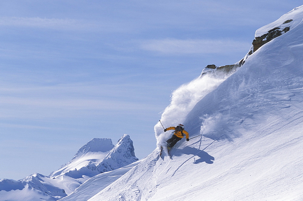 Female skier (Sarah Oakden) skiing at Mica Helisking near Mica Creek, BC, Canada