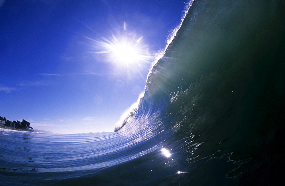 California wave breaking against the shallow sand in Santa Barbara, California.