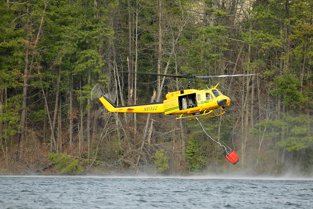 NC Forestry Service helicopter dips its bucket into Lake Julian while fighting a fire near Arden, NC.