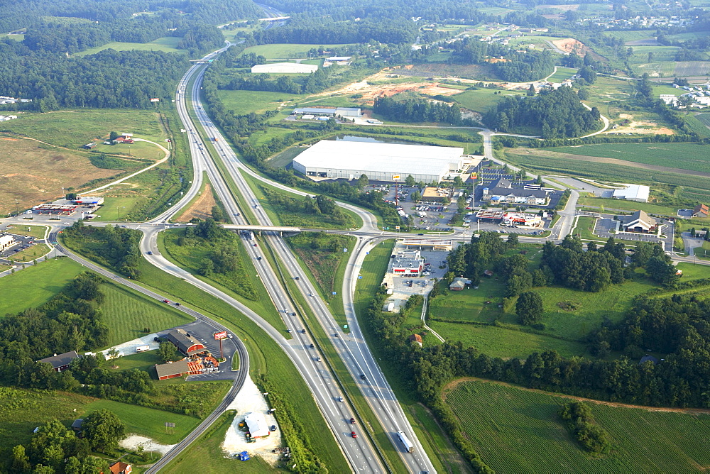 Aerial view of commercial growth clustered around an interstate exit near Hendersonville, NC.