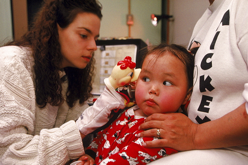 Hearing tests with 2 year old Angie. Hearing problems are found in about 25% of Inuit kids. Angie is suffering from an infection called "otitis media".