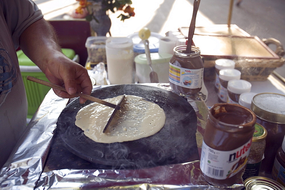 Batter cooking on a iron skillet in Aix-En-Provence, France.