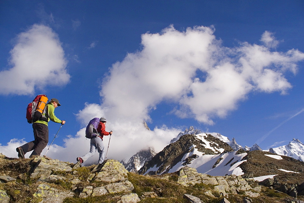 Two hikers climb a ridge near Mont Blance in France.