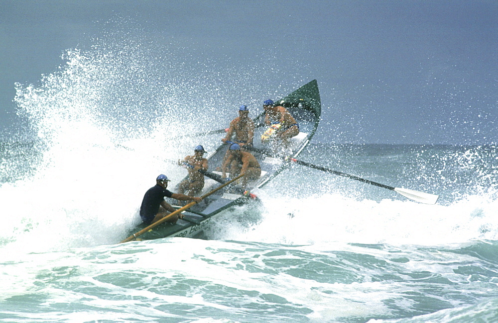 A group of people on a surf boat during a surf carnival in Sydney, Australia.