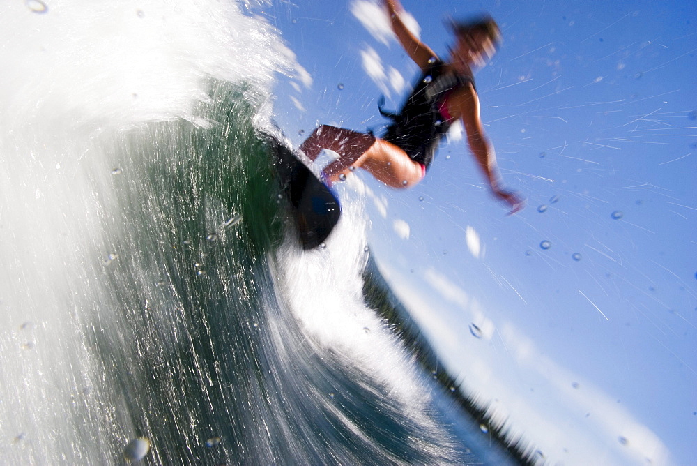 Woman wake boarding on sunny day, Idaho