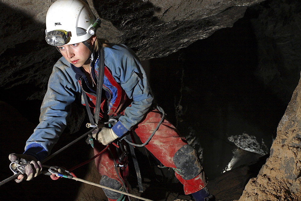 Katie Dent climbs up a rope in a cave in the White Mountains on Crete.