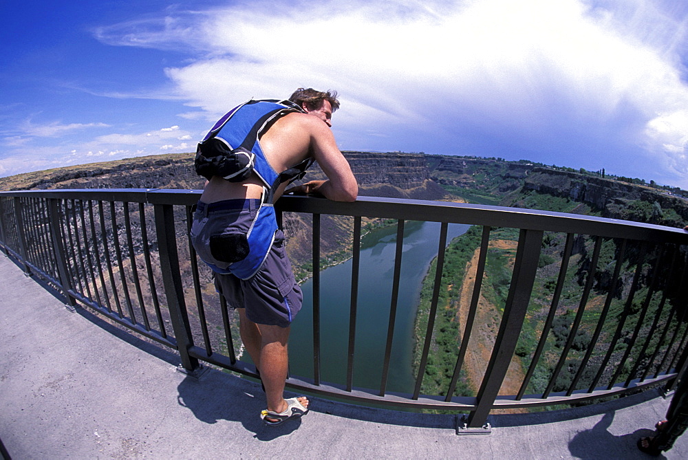 A BASE jumper looks over a bridge in Twin Falls, Idaho (Wide Angle Lens).