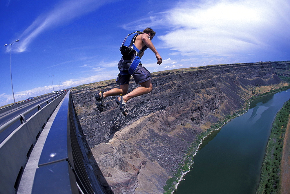 A BASE jumper jumps off a bridge in Twin Falls, Idaho (Wide Angle Lens).