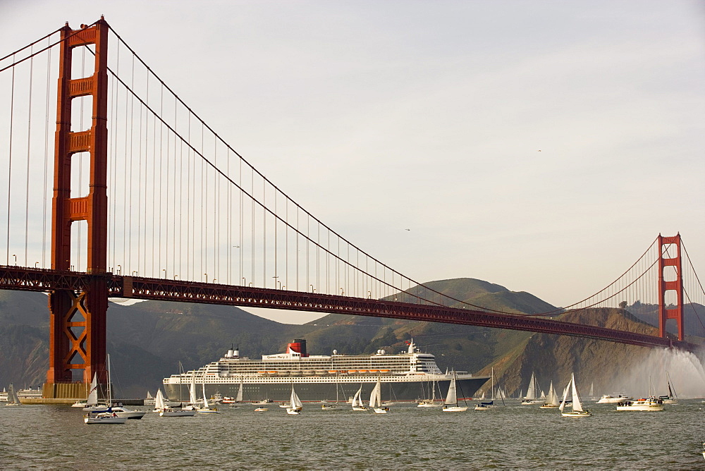 A cruise ship sails under the Golden Gate Bridge in San Francisco, California.