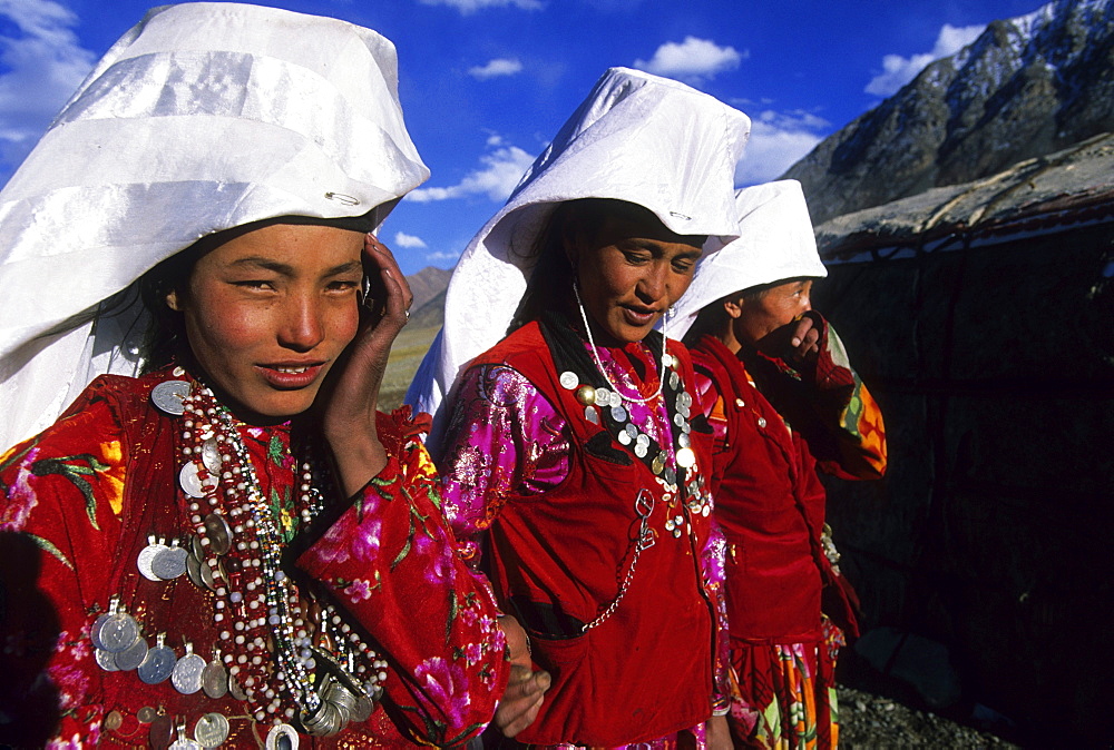 Kirghiz women in traditional dress outside of their yurt camp, Little Pamir, Wakhan, Afghanistan