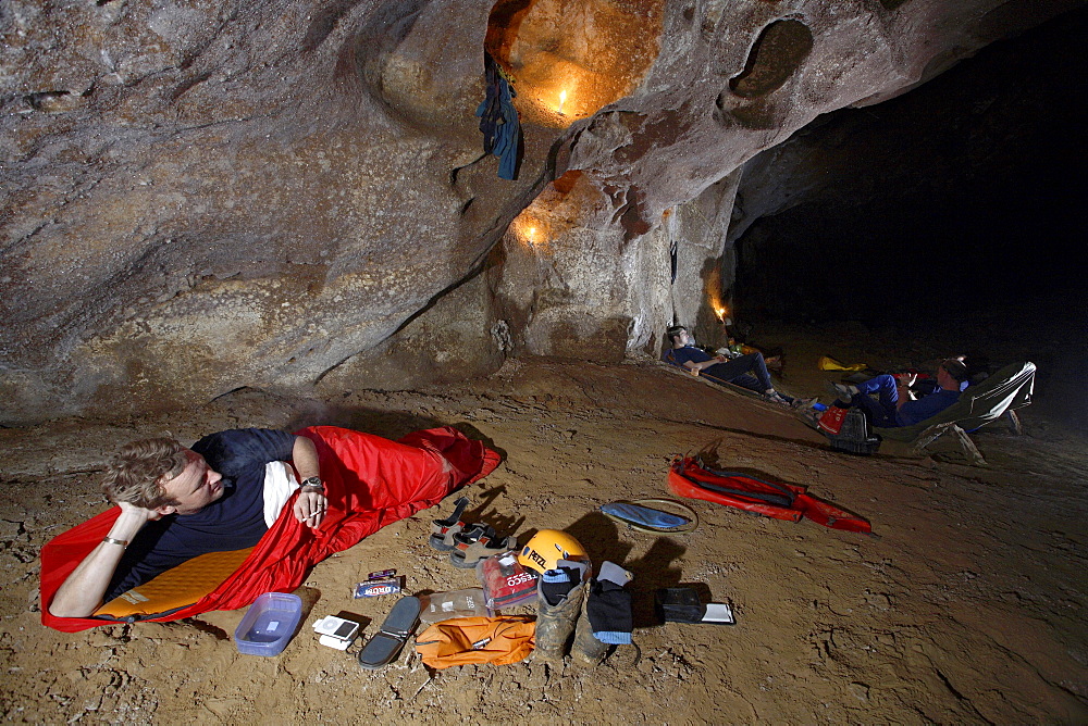 One cave explorer delays the dreaded task of getting up from his sleeping bag and put on his cold wet clothes again from the day