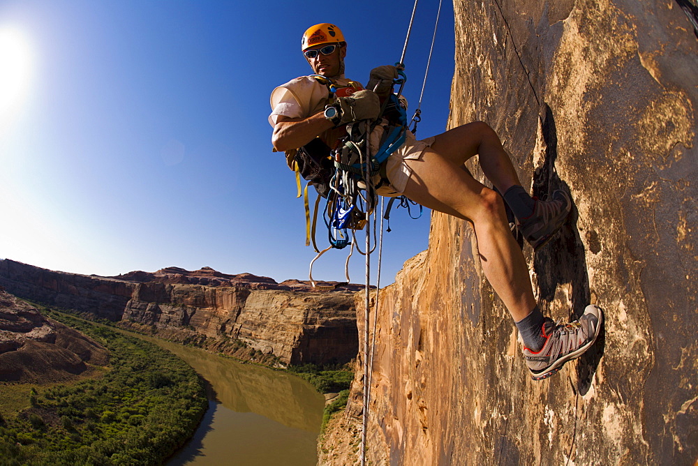 Adventure racer rappelling over a river in a race in Moab, Utah.